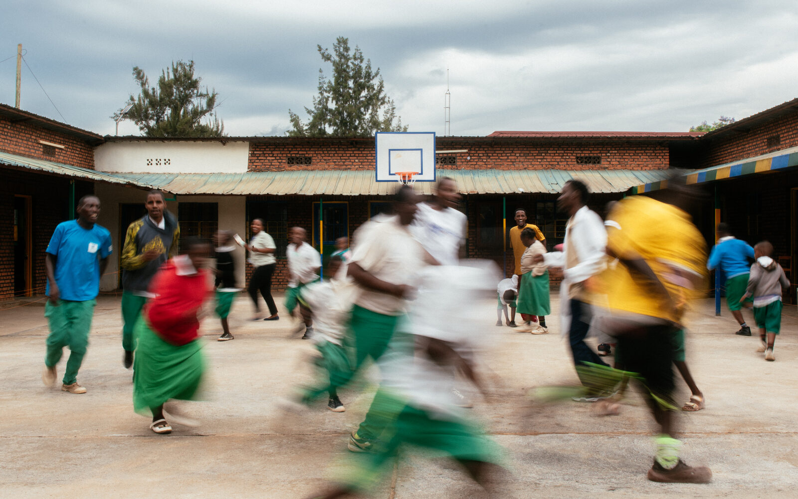 Children running across a school courtyard